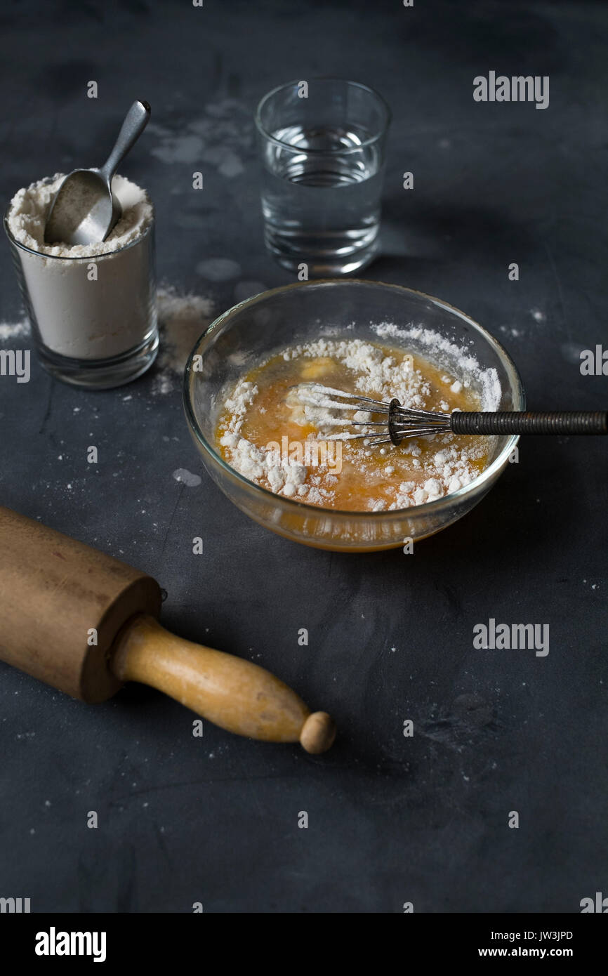 Mixing together ingredients of hot-water crust pastry dough, using wooden  spoon Stock Photo - Alamy