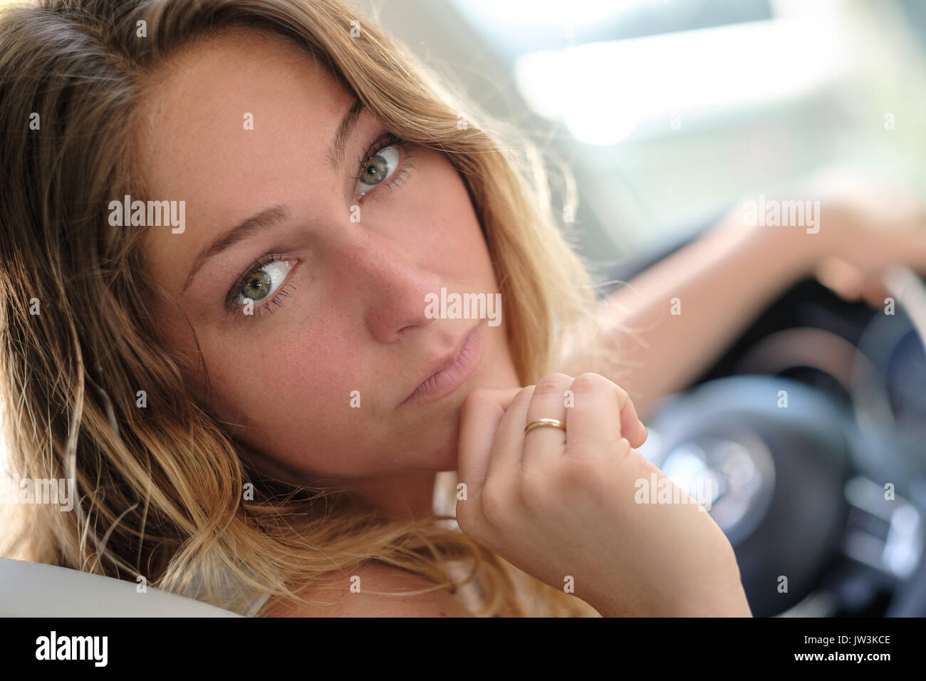 Portrait of woman in car driving Stock Photo