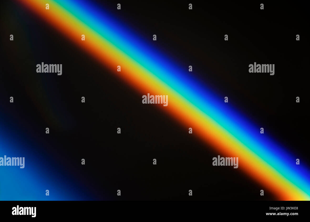 Rainbow prism light against black Stock Photo