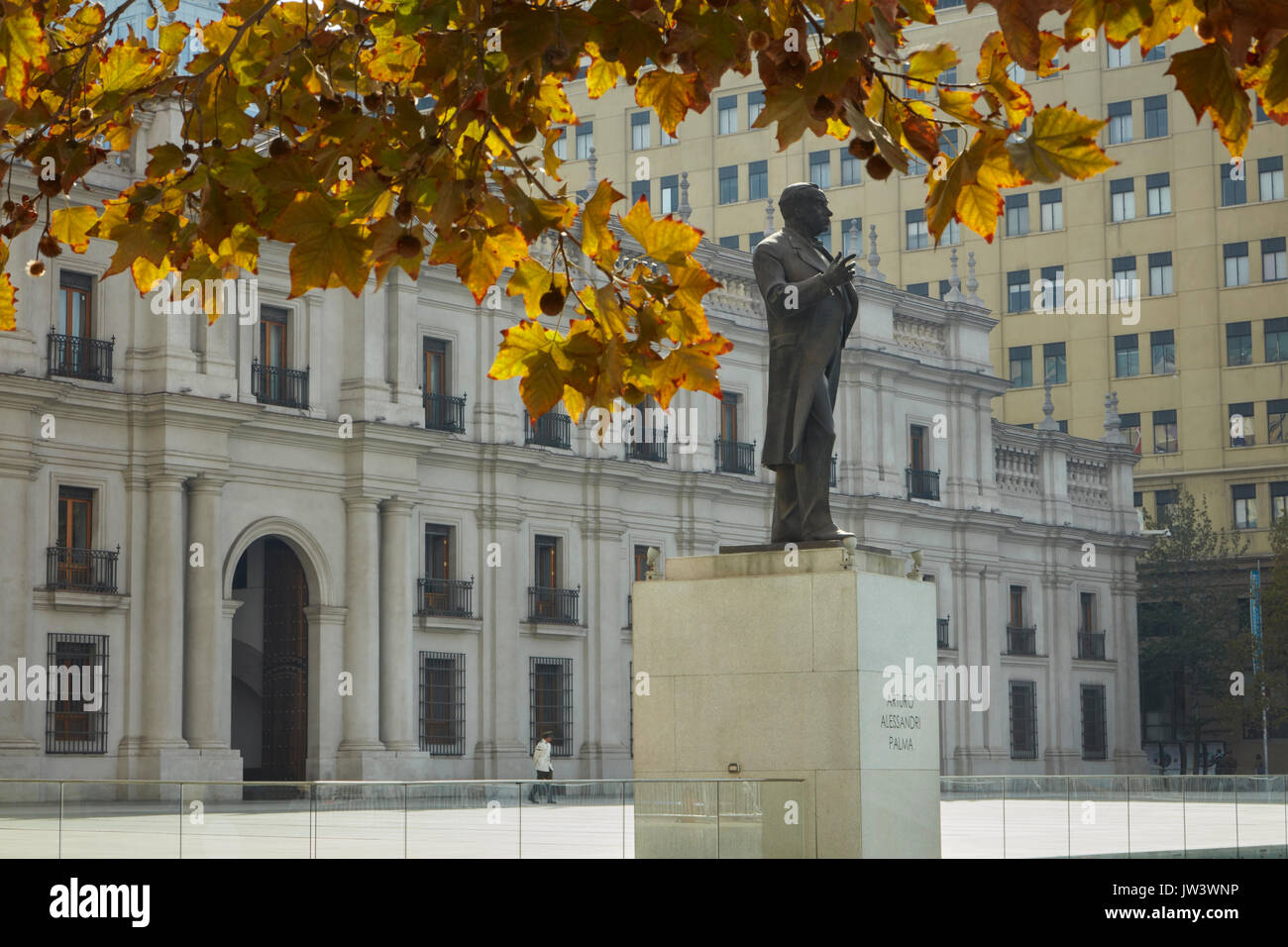 Autumn colour & statue of Arturo Alessandri (former president) outside La Moneda, Plaza de la Ciudadania, Santiago, Chile, South America Stock Photo