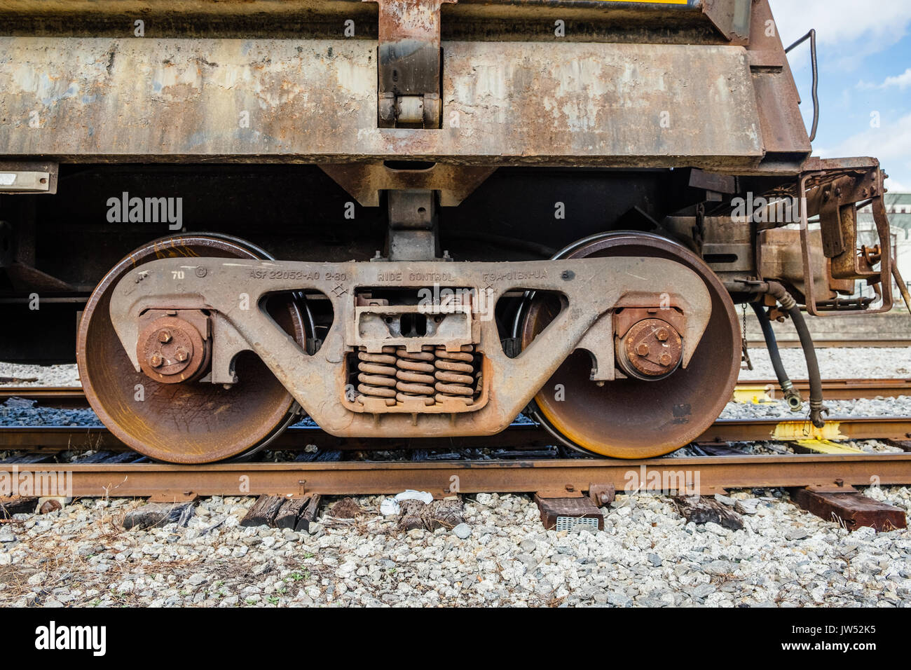 A rusted empty gondola railroad car, sitting on a siding spur in Opelika, Alabama, USA. Stock Photo