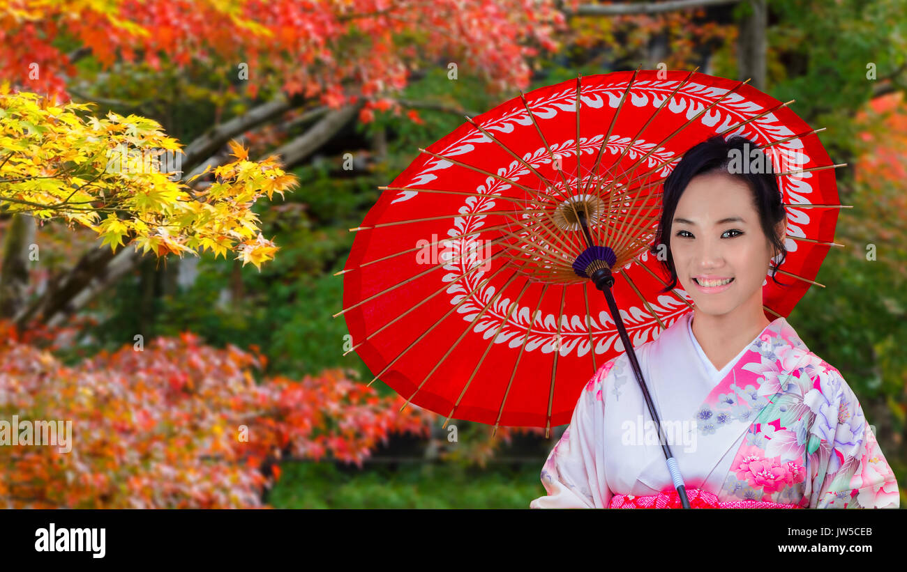 Japanese Girl witha Traditional Red Umbrella in Colorful Autumn Stock Photo