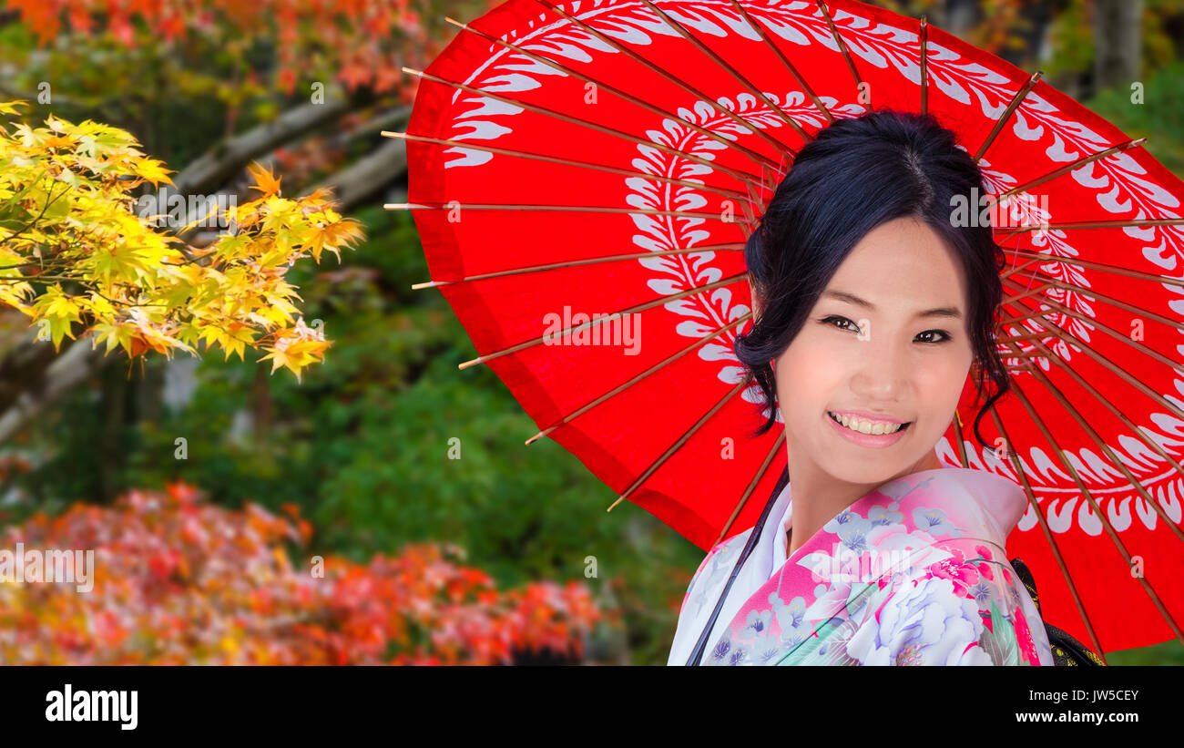 Japanese Girl witha Traditional Red Umbrella in Colorful Autumn Stock Photo