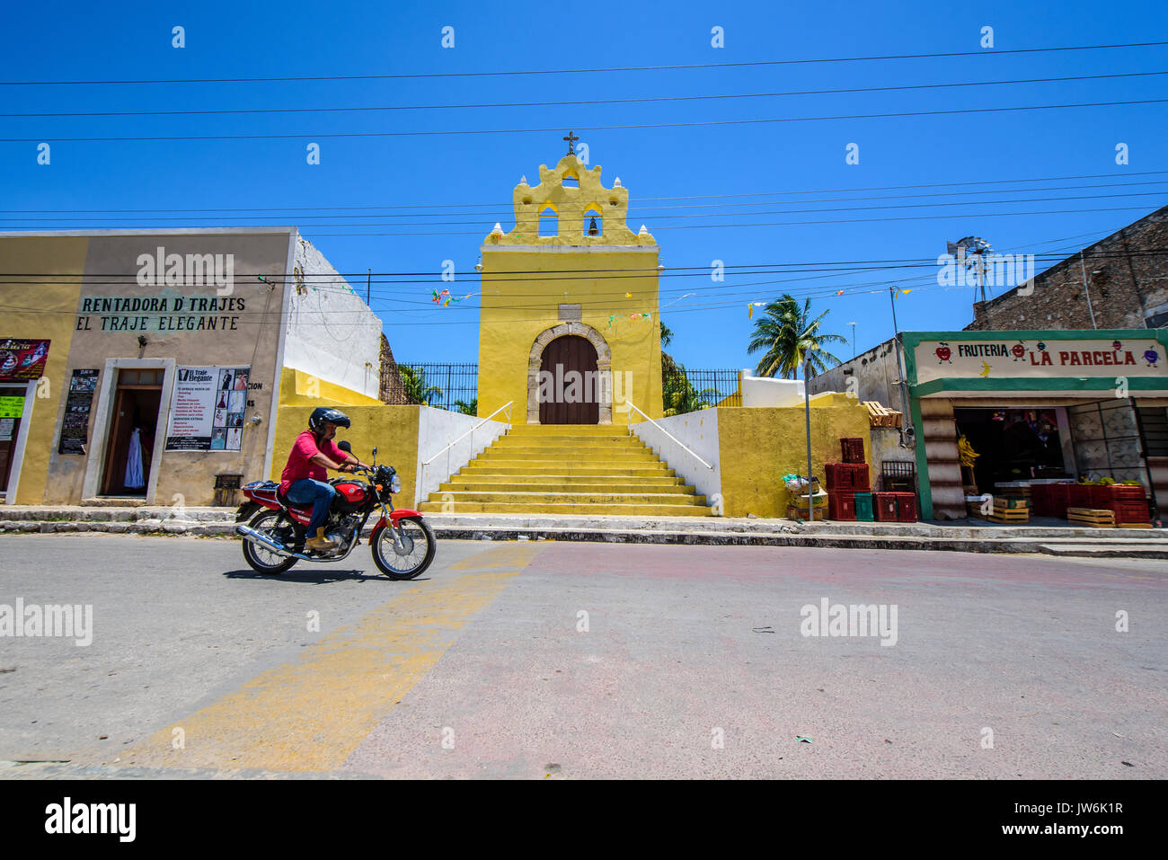 Motorist driving in front of the Chapel in Acanceh, Yucatan state, Mexico Stock Photo