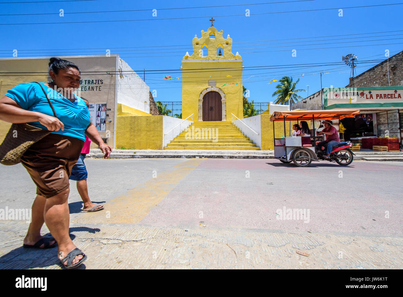 Woman walking in front of the Chapel in Acanceh, Yucatan state, Mexico Stock Photo