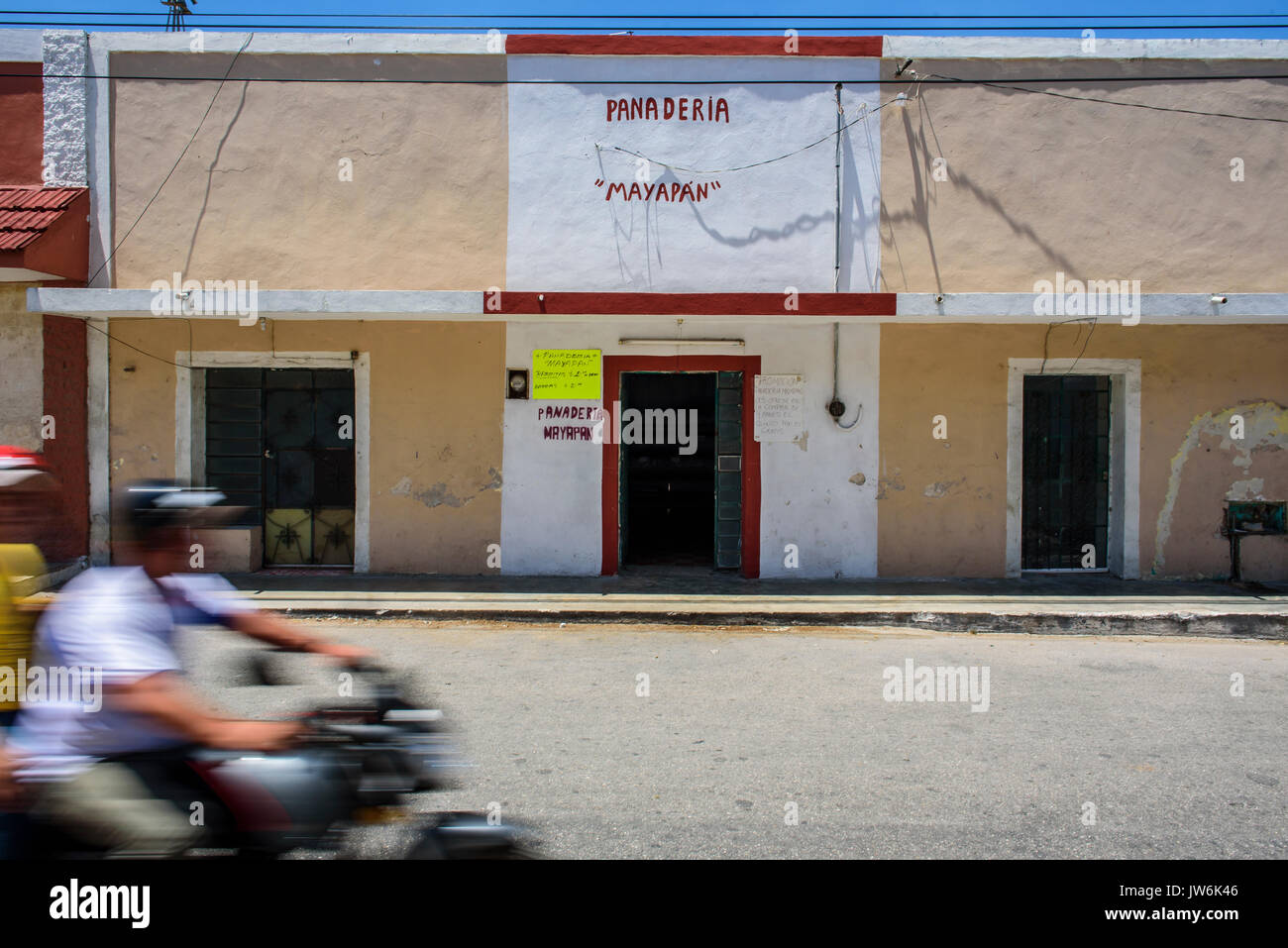 Moto driving in front of a traditional bakery in Acanceh street, Yucatan state, Mexico Stock Photo