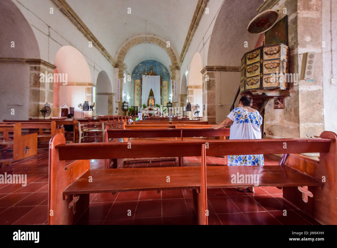 Women praying in the church of the convent of Mama, Yucatan (Mexico) Stock Photo
