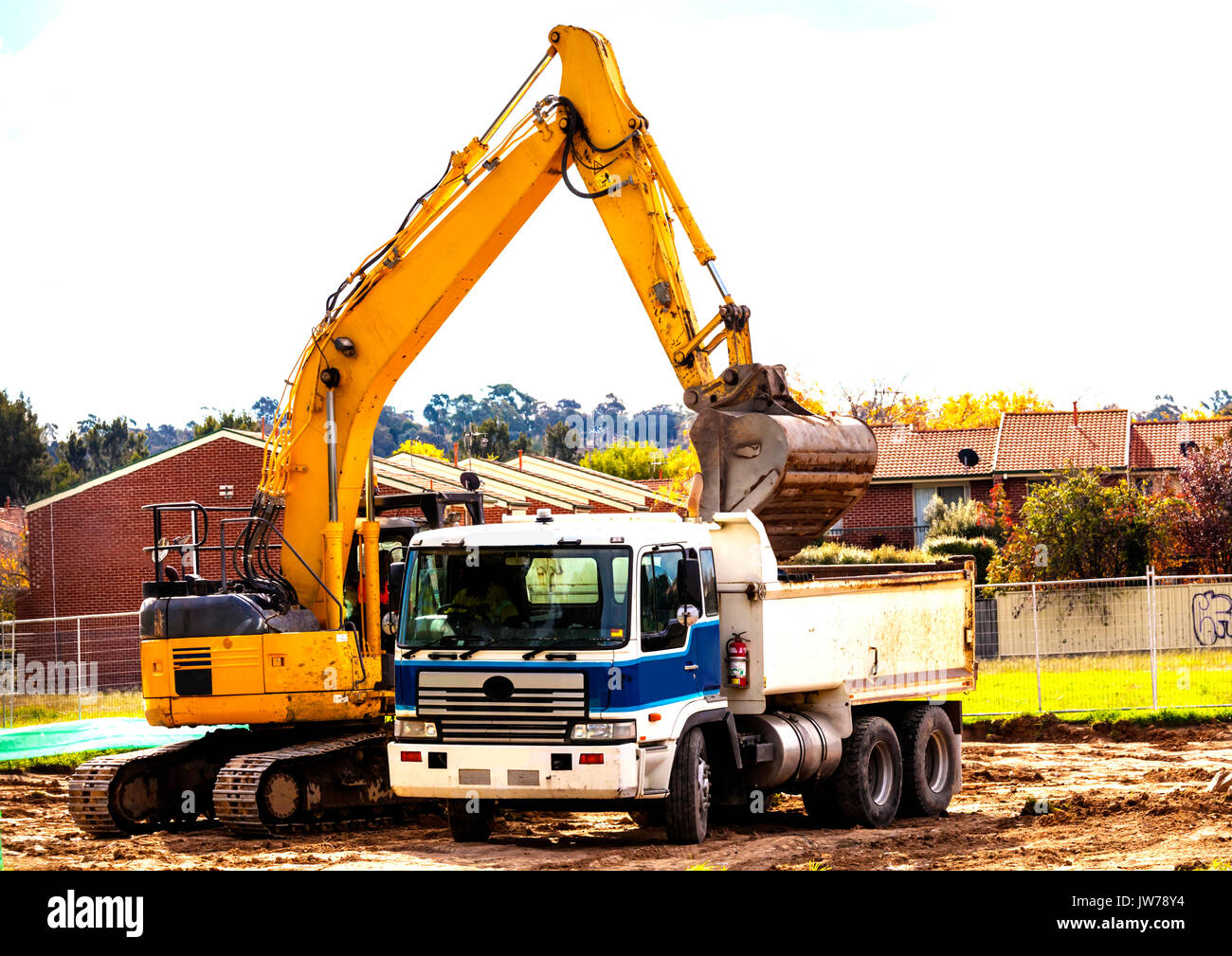 Loading soil for removal into tip truck Stock Photo