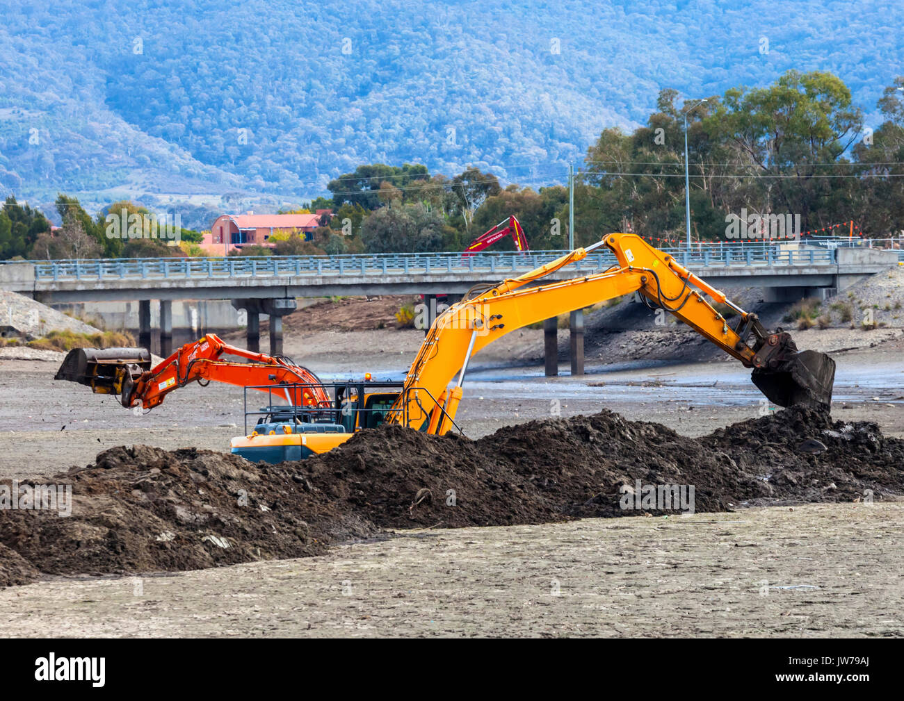 Two front end loaders dredging Isabella Ponds to remove carp and widen the lake Stock Photo Alamy