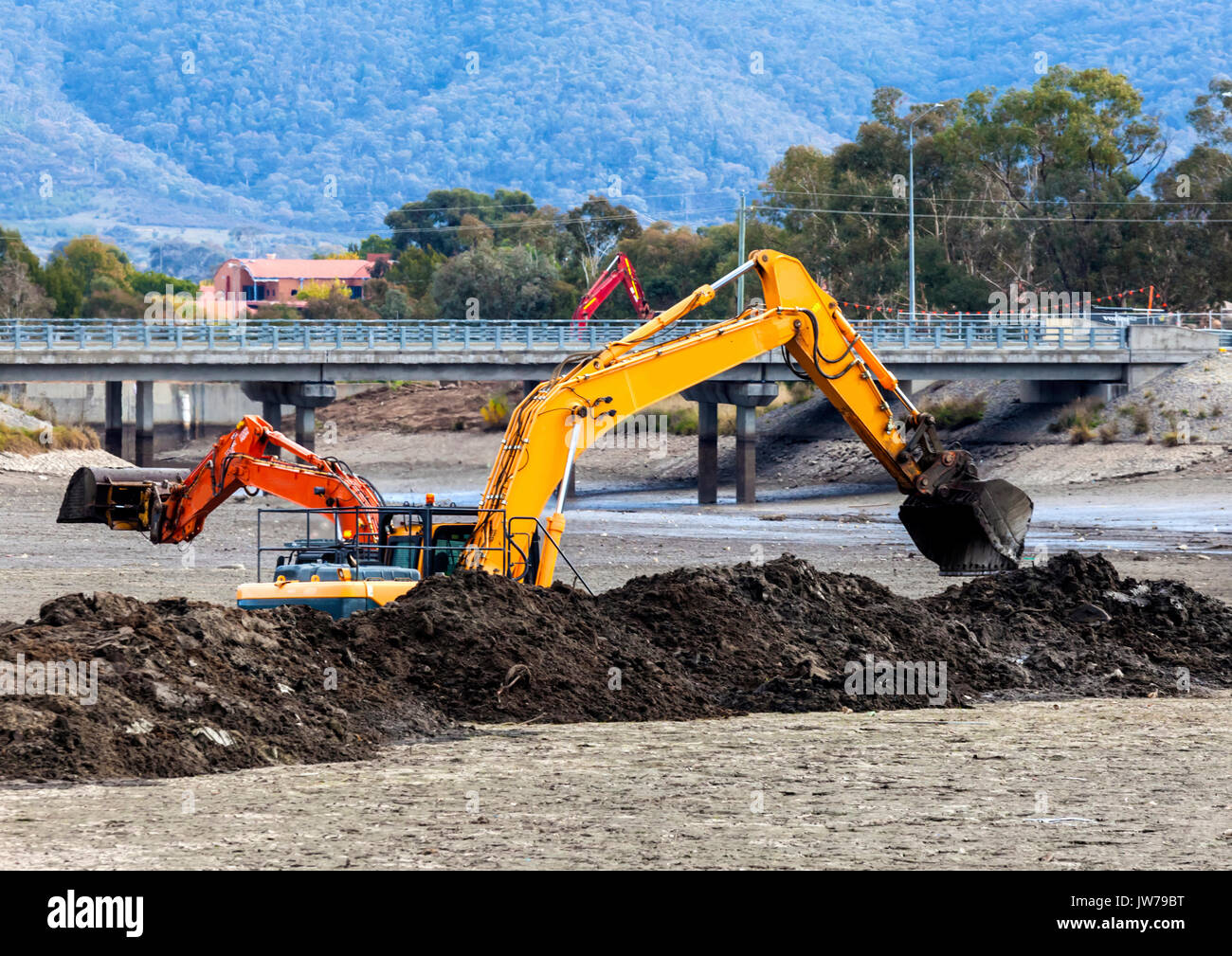 Two front end loaders dredging Isabella Ponds to remove carp and widen the lake Stock Photo Alamy
