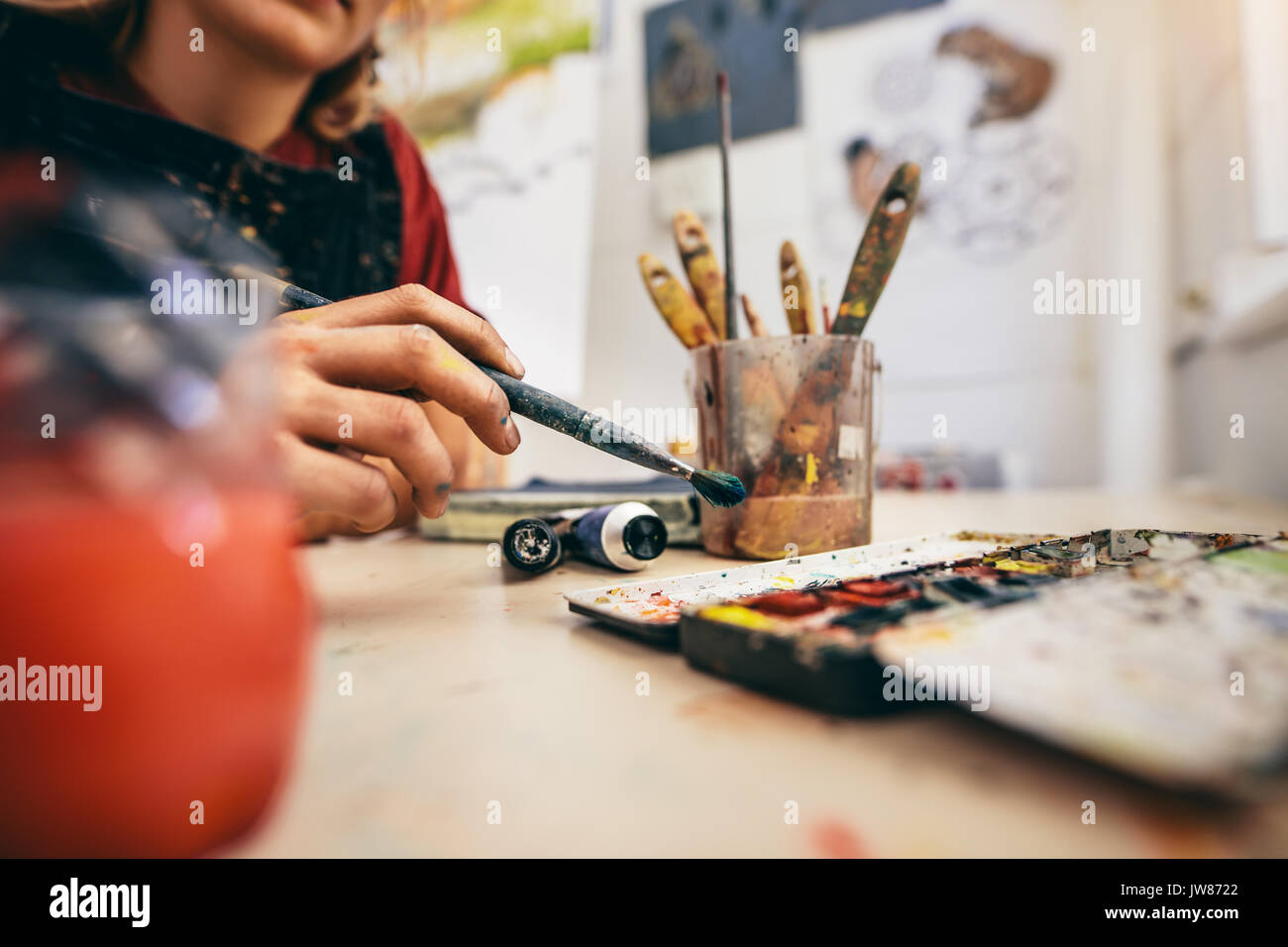 https://c8.alamy.com/comp/JW8722/close-up-shot-of-female-artist-hand-holding-brush-and-drawing-picture-JW8722.jpg