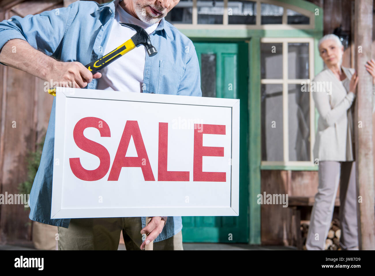 close up of sale sign, senior couple selling their house Stock Photo ...