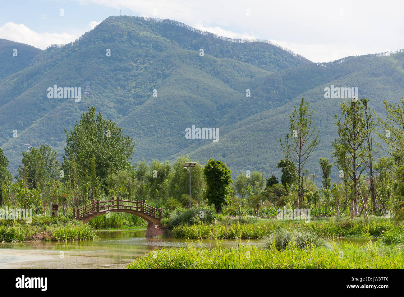 Mountain landscape with a wodden bridge in Xichang Stock Photo