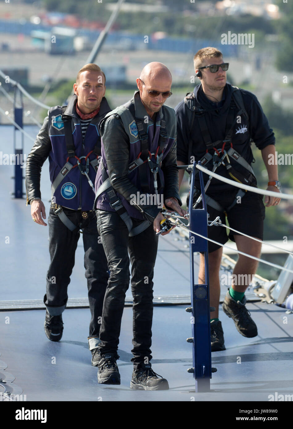 Matt (left) and Luke Goss (centre) of boy band Bros climb to the top of the O2 Arena in London for a photocall ahead of their comeback tour, which will see them play two gigs at the venue later this month. Stock Photo