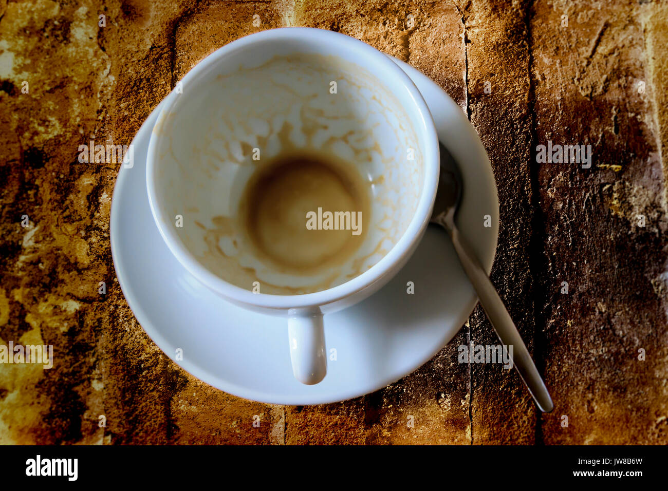 Used coffee cup and saucer on a rough stone background Stock Photo Alamy