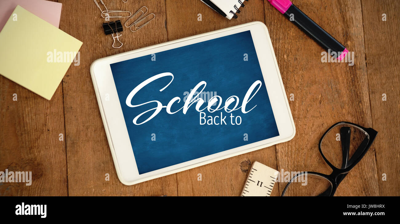 Back to school text over white background against digital tablet with school supplies and eyeglasses on table Stock Photo