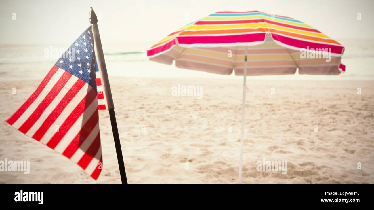 Flare against beach umbrella at tropical sand beach Stock Photo
