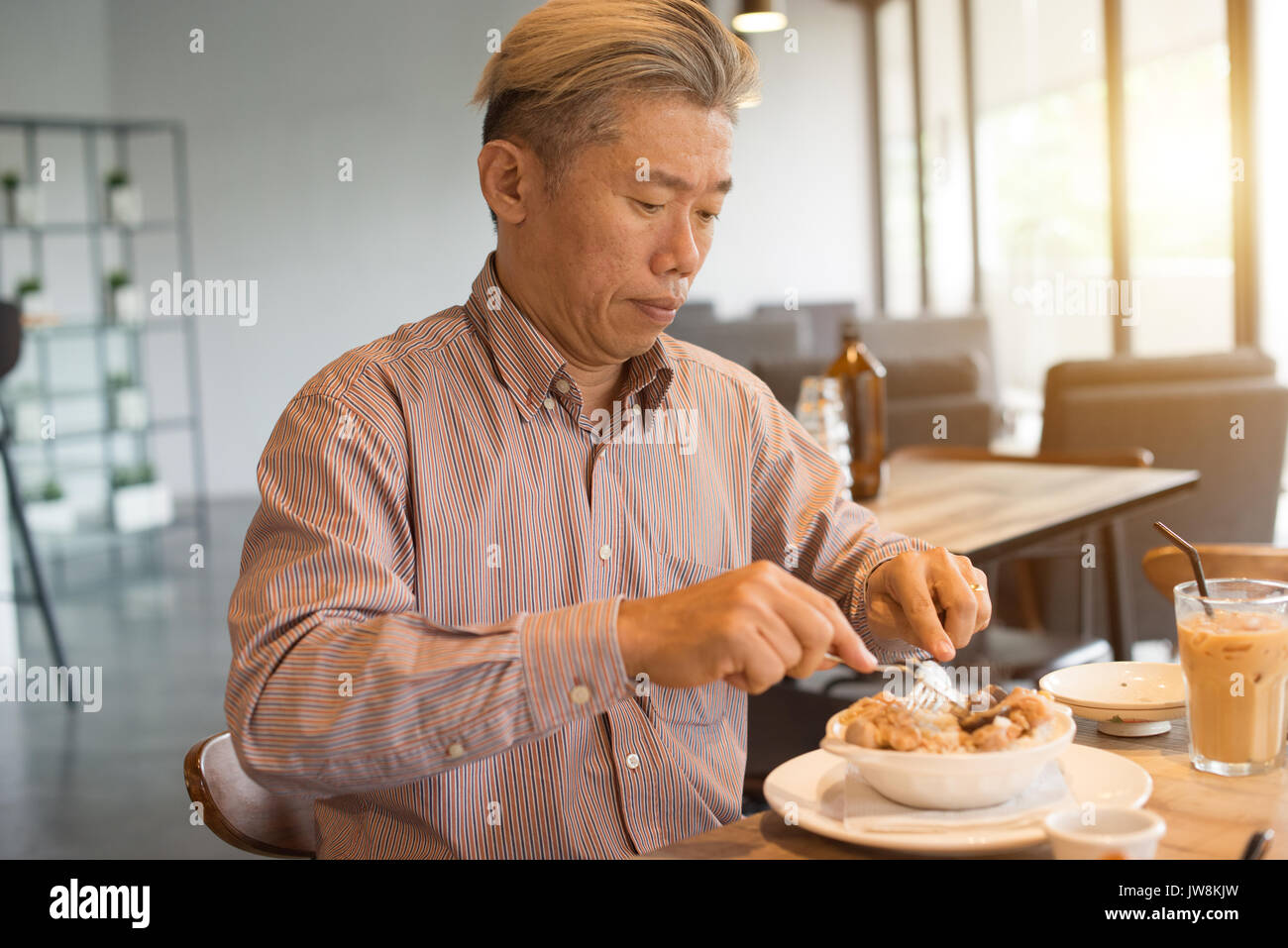 matured asian business male having breakfast Stock Photo