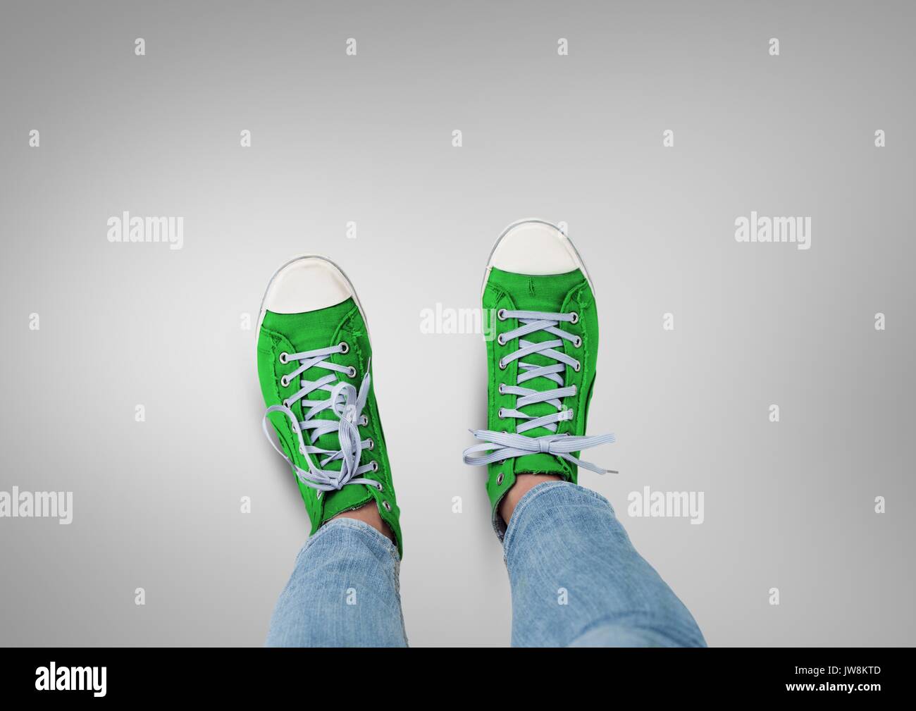 Digital composite of Green shoes on feet with grey background Stock ...