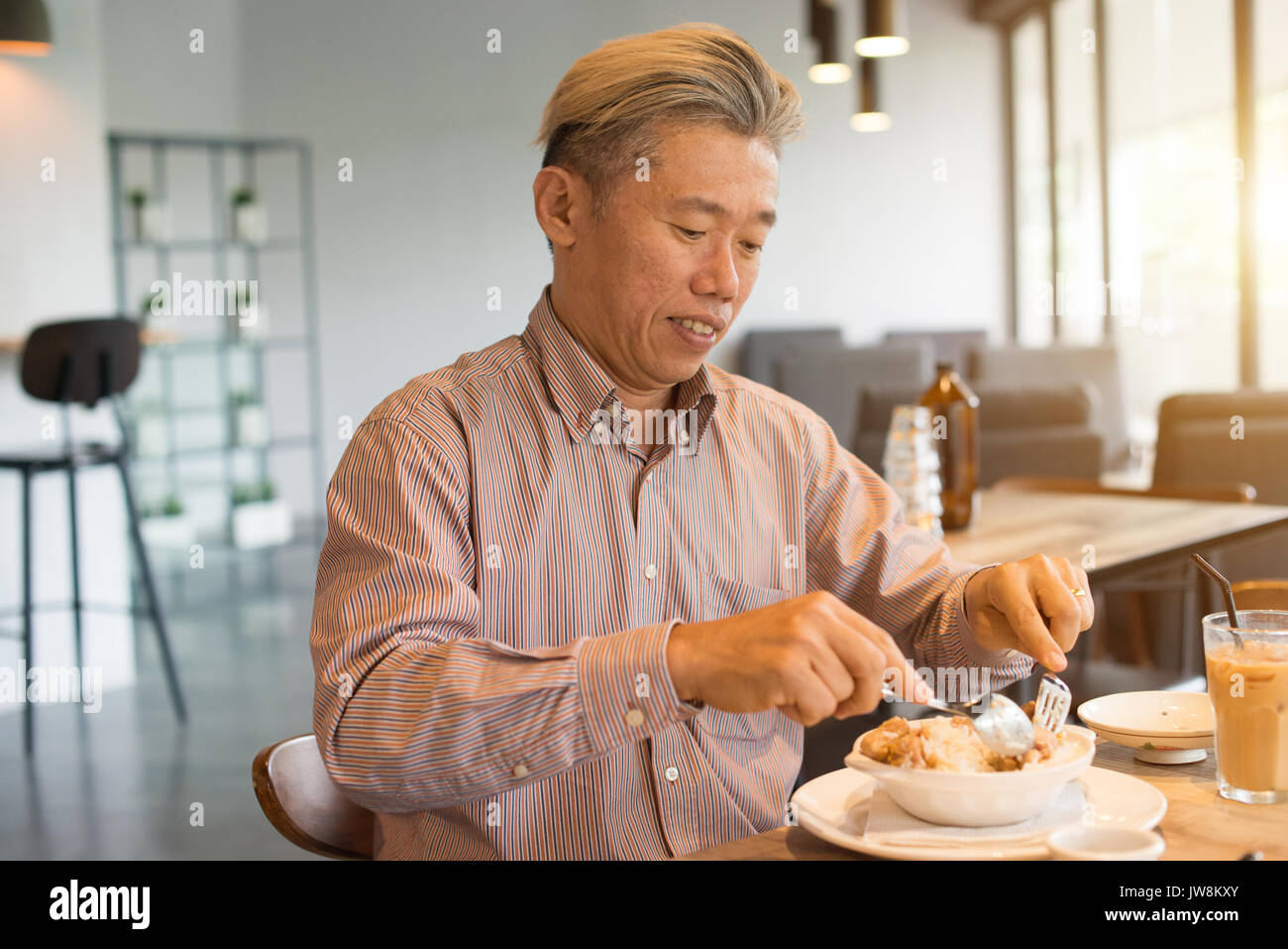 matured asian business male having breakfast Stock Photo