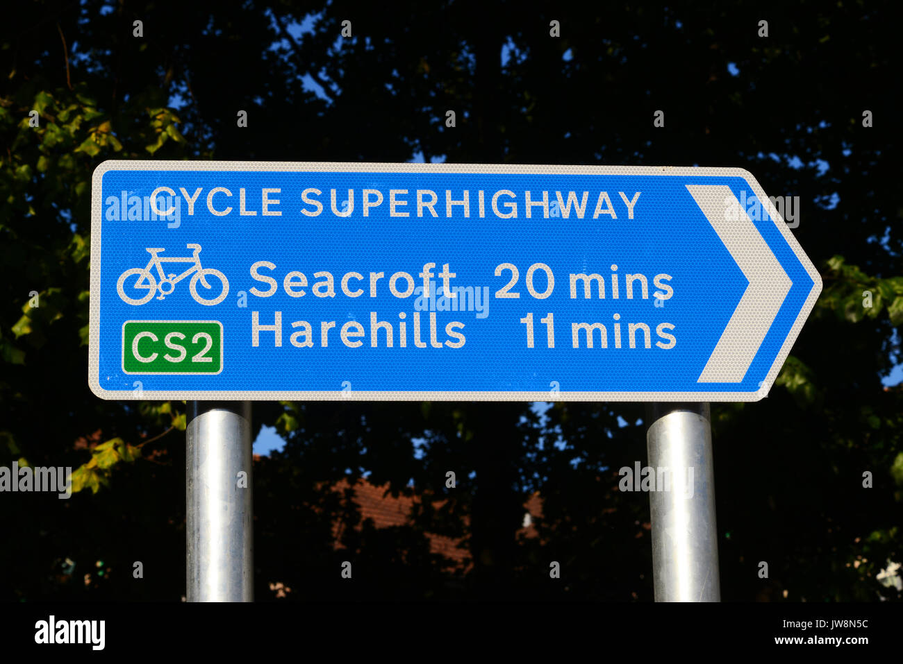 cyclist by direction and distance sign on leeds cycling super highway leeds Yorkshire UK Stock Photo