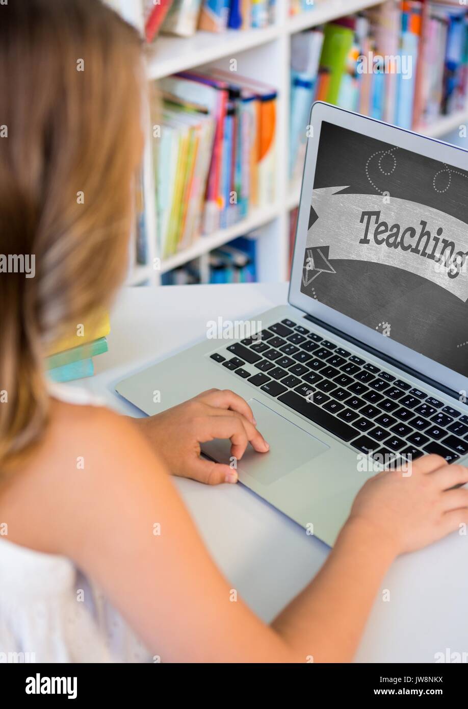 Digital composite of Girl using a computer with school icon on screen ...