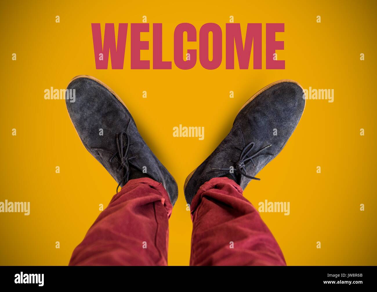 Digital composite of Welcome text and Grey shoes on feet with yellow ...