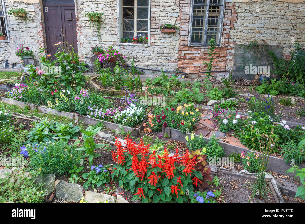 Cottage rustical raised beds in a garden, Country old rural house Czech Republic Stock Photo