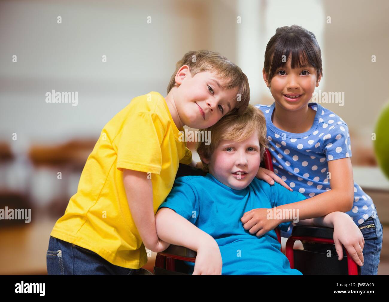 Digital composite of Disabled boy in wheelchair with friends in school classroom Stock Photo