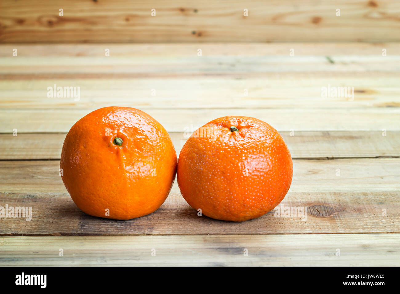 Fresh oranges on wooden table Stock Photo