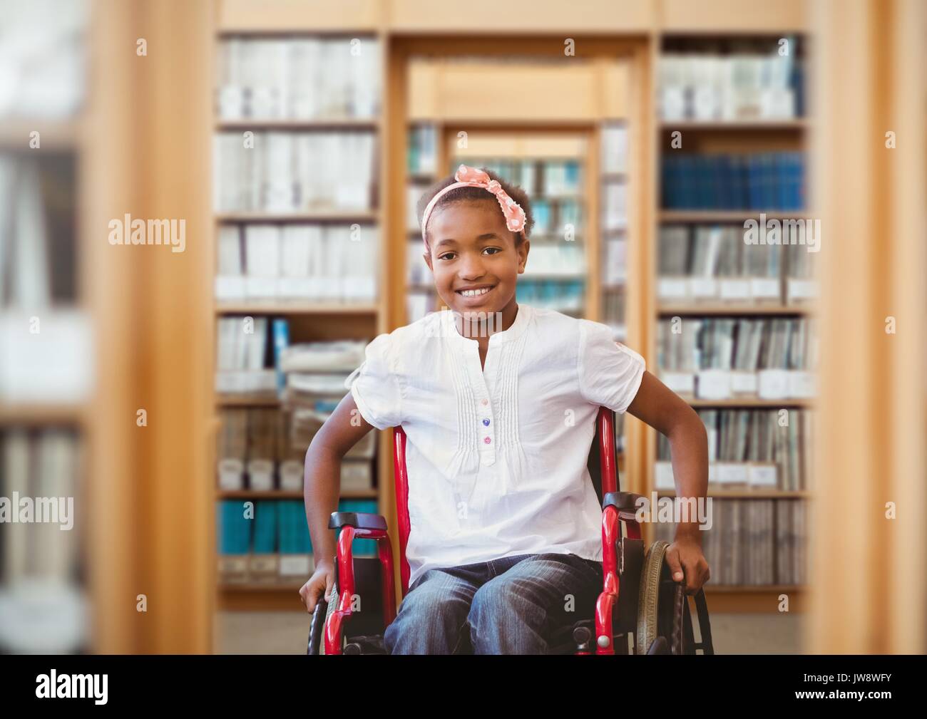 Digital composite of Disabled boy in wheelchair in school library Stock Photo