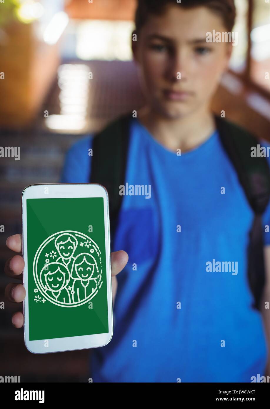 Digital composite of Boy holding a phone with school icons on screen Stock Photo