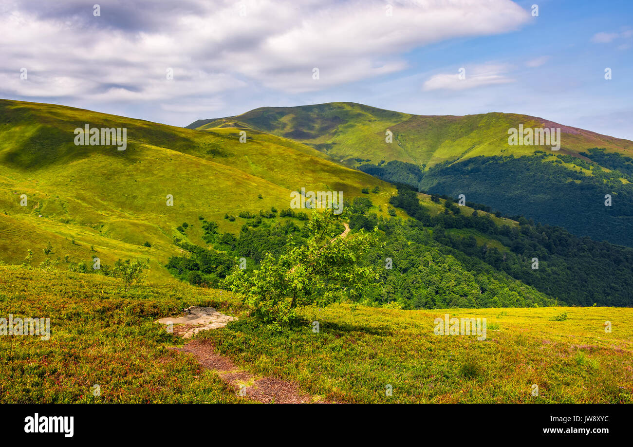 path on the edge of hillside on mountain ridge. Beautiful travel scenery with hills in summer time Stock Photo
