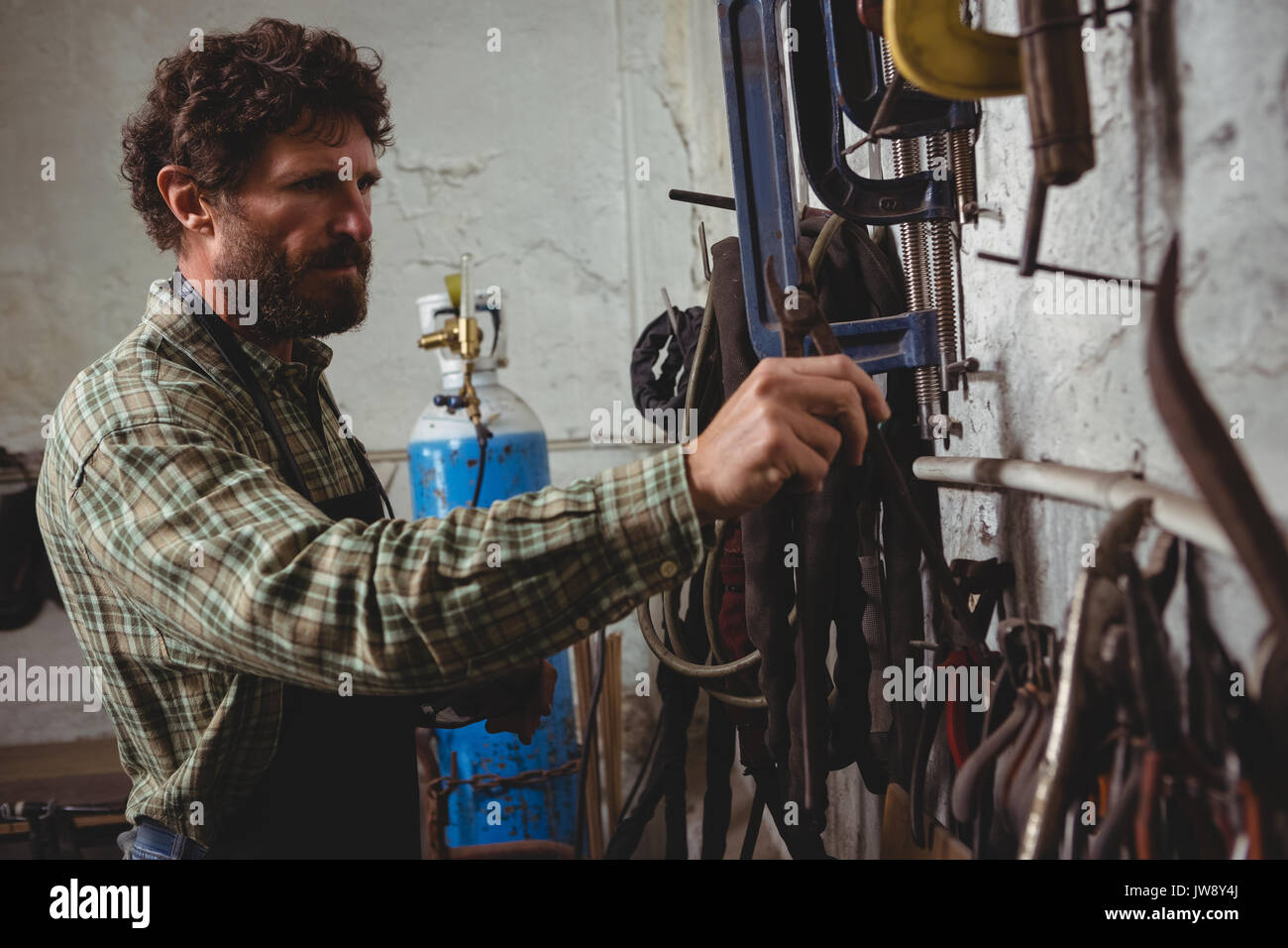 Attentive craftsman working in workshop Stock Photo