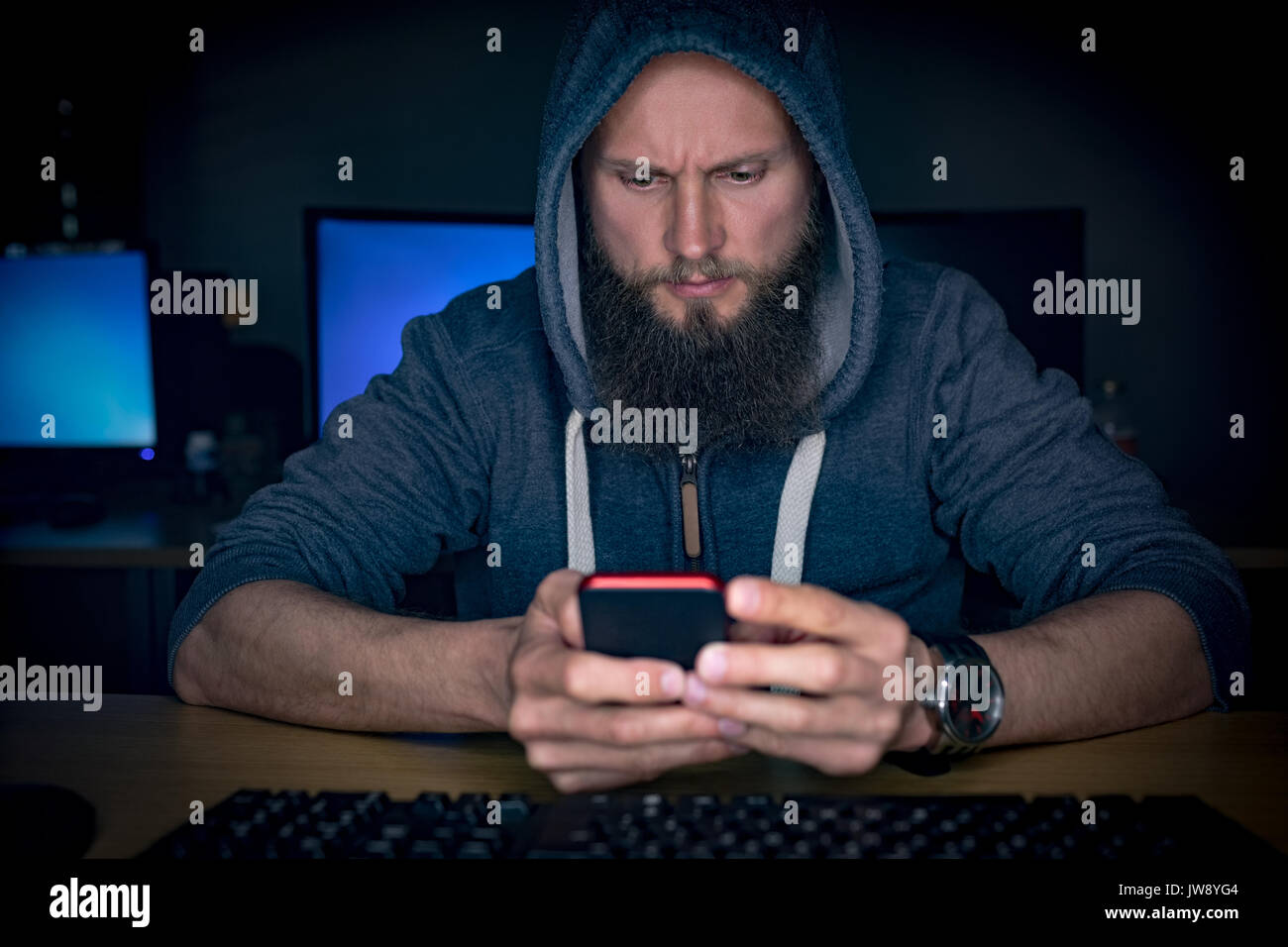 Executive using mobile phone at desk in office Stock Photo