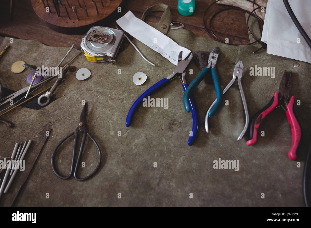 Various metal tools on wooden table in workshop Stock Photo