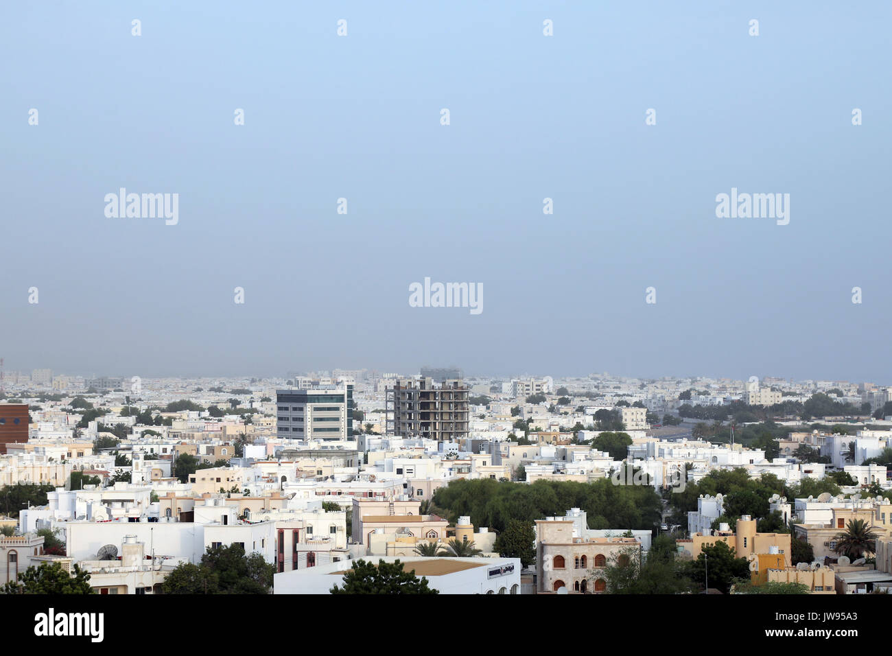 The predominantly low-rise homes, offices and other buildings in the Al Badi area of the Omani capital, Muscat on 8 August 2017 Stock Photo