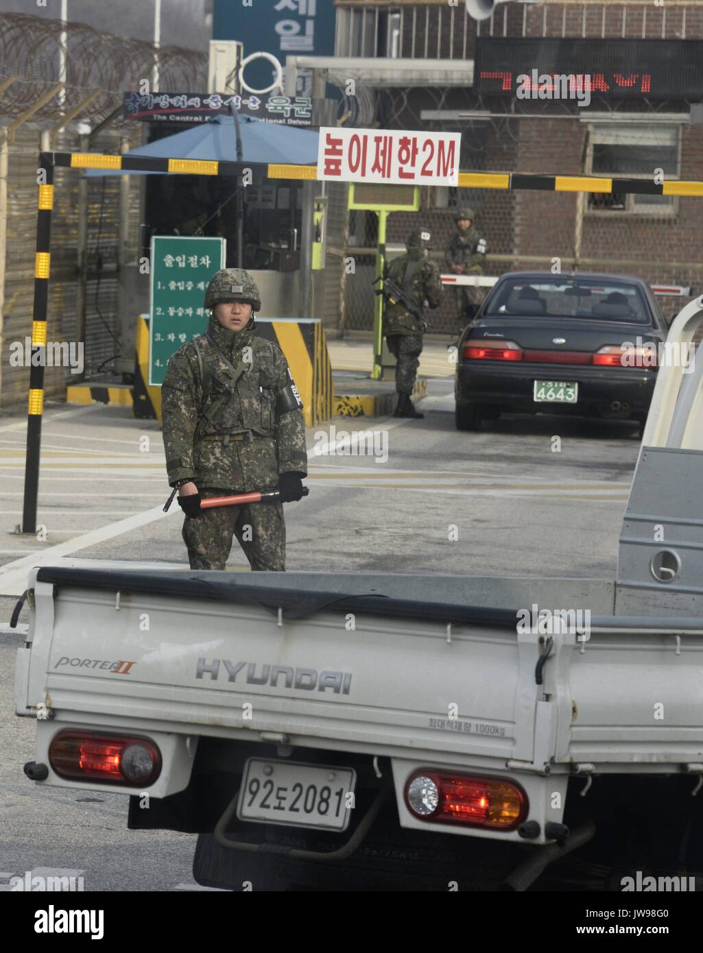 A South Korean soldier patrols cars entering the DMZ along the fenced border between South and North Korea, some 80 km north of Seoul, South Korea, 28 March 2013. South and North Korea are technically still at war after the 1950 to 1953 Korean war ended in an armistice and the Korean peninsular remains divided since then. A 250 km long and some four km wide demilitarized Zone (DMZ) runs across the Korean peninsular and is regarded as the most militarized border in the world. | usage worldwide Stock Photo