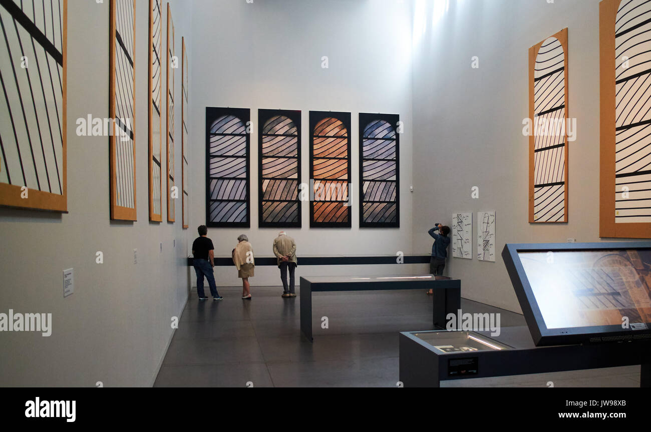Europe, France, Occitanie,Aveyron, Rodez city, Pierre-Soulages museum, The visituer looks at a painting of the Outrenoirs serie by French painter Pierre Soulages at the Soulages museum Stock Photo