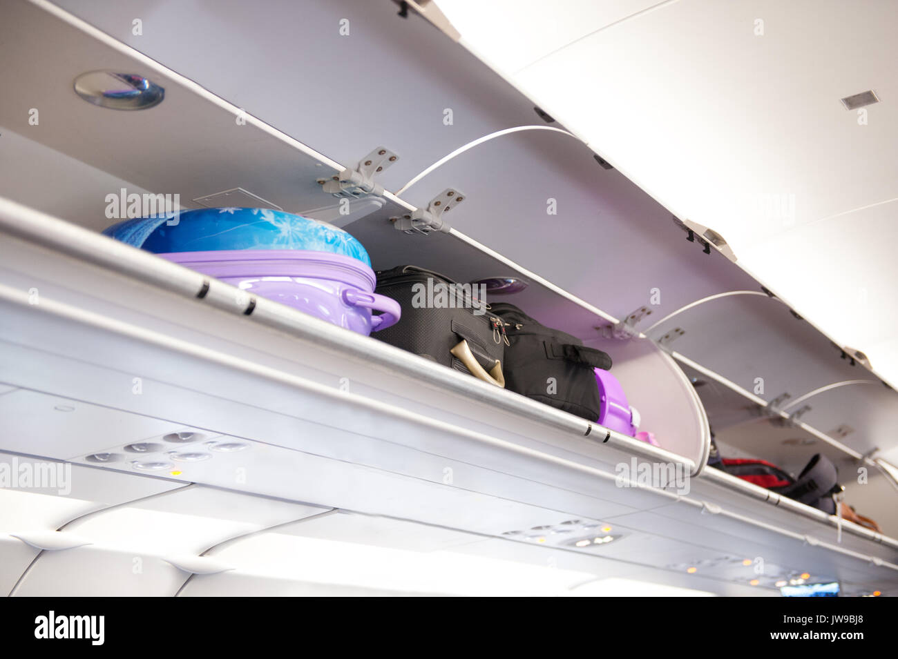 overhead locker on an airplane or plane Stock Photo
