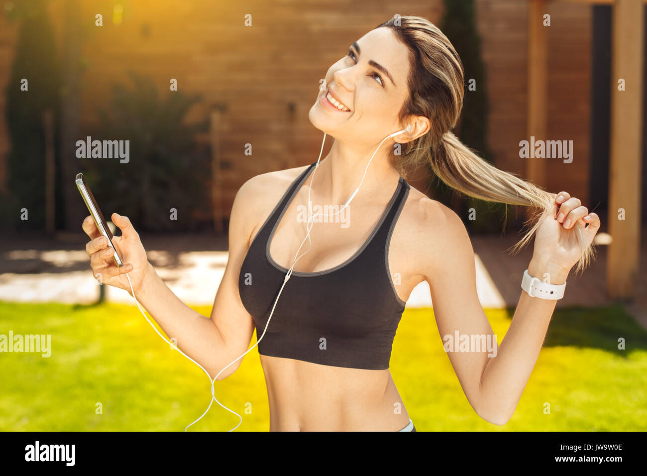 Young female exercise in the park listening music Stock Photo