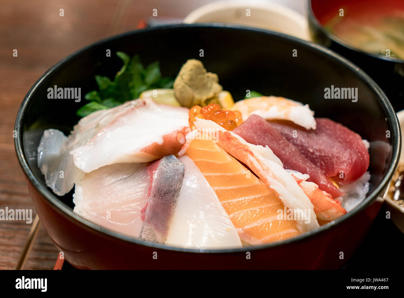 Japanese food with raw fishes, called sashimi on the rice in Bowl in