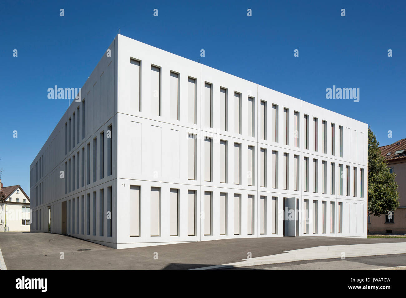 Oblique elevation of entrance facade with closed blinds. Finanzamt / Finance Office Biberach, Biberach, Germany. Architect: hartwig schneider architek Stock Photo