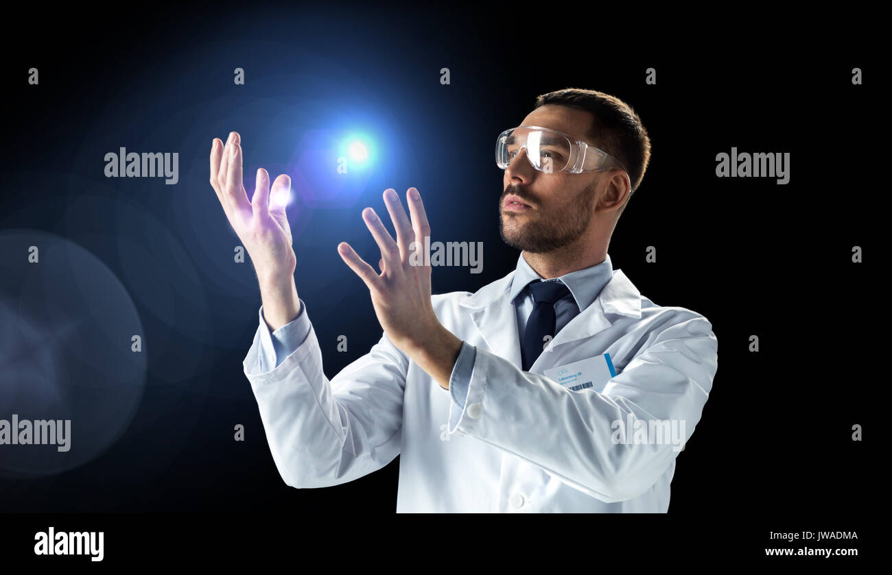 scientist in lab coat and goggles with light Stock Photo Alamy
