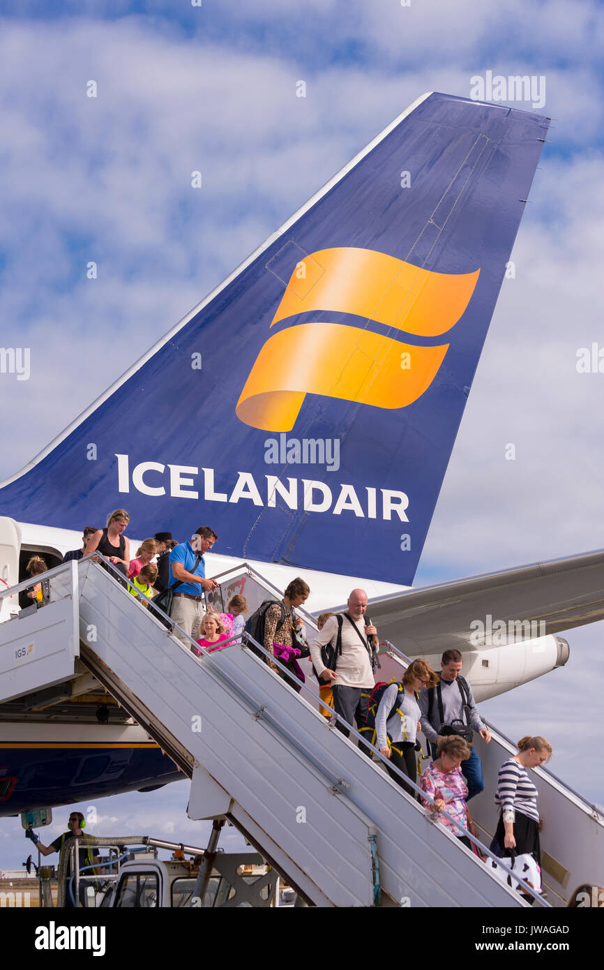 KEFLAVIK INTERNATIONAL AIRPORT, ICELAND - Arriving passengers getting off Icelandair jetliner. Stock Photo