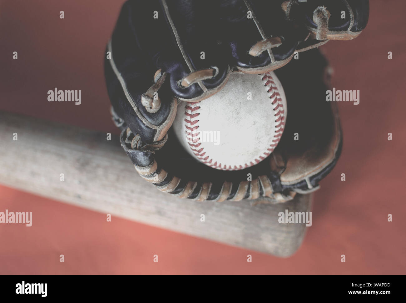 Vintage style image of baseball bat, ball glove and old leather ball for sports background.  Shows game equipment. Stock Photo