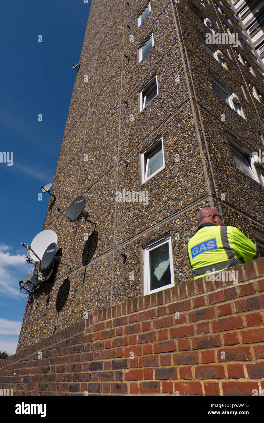Gas contractors talking outside estate. Southwark local authority cut