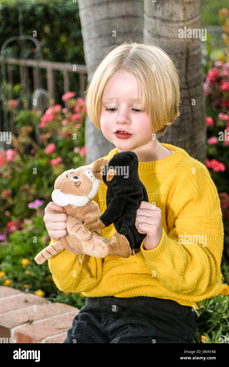 young girl plays out story with two stuffed animals as characters 4-5 years old outdoors outside Caucasian  © Myrleen Pearson Stock Photo