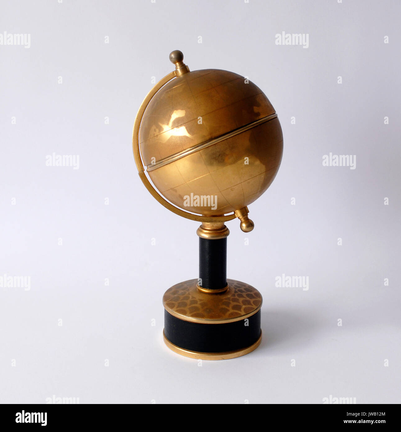 Vintage brass cigarette dispenser with globe. World map Stock Photo