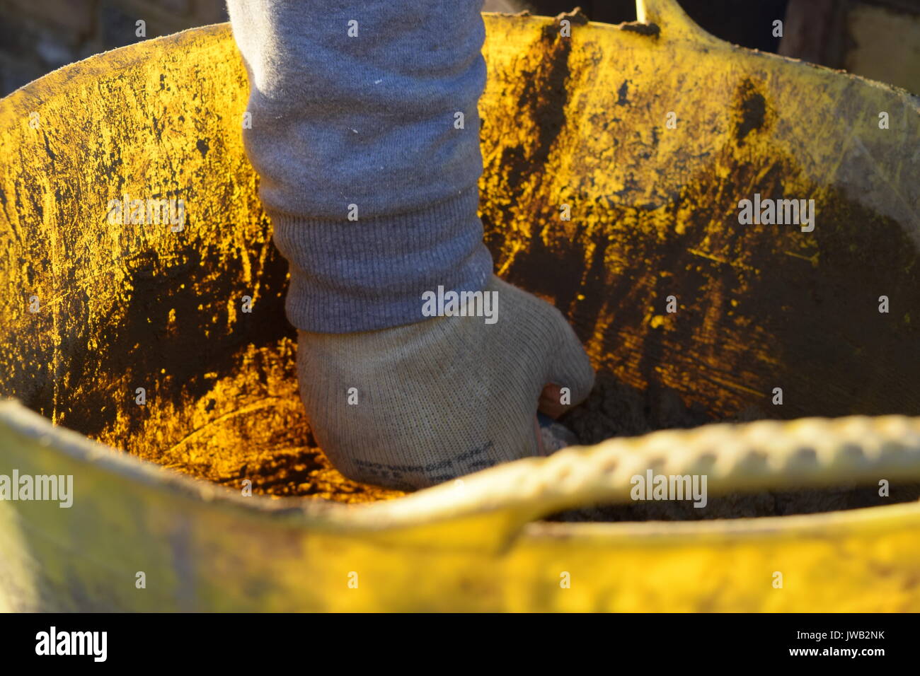 Brick layer holding a trowel with cement Stock Photo